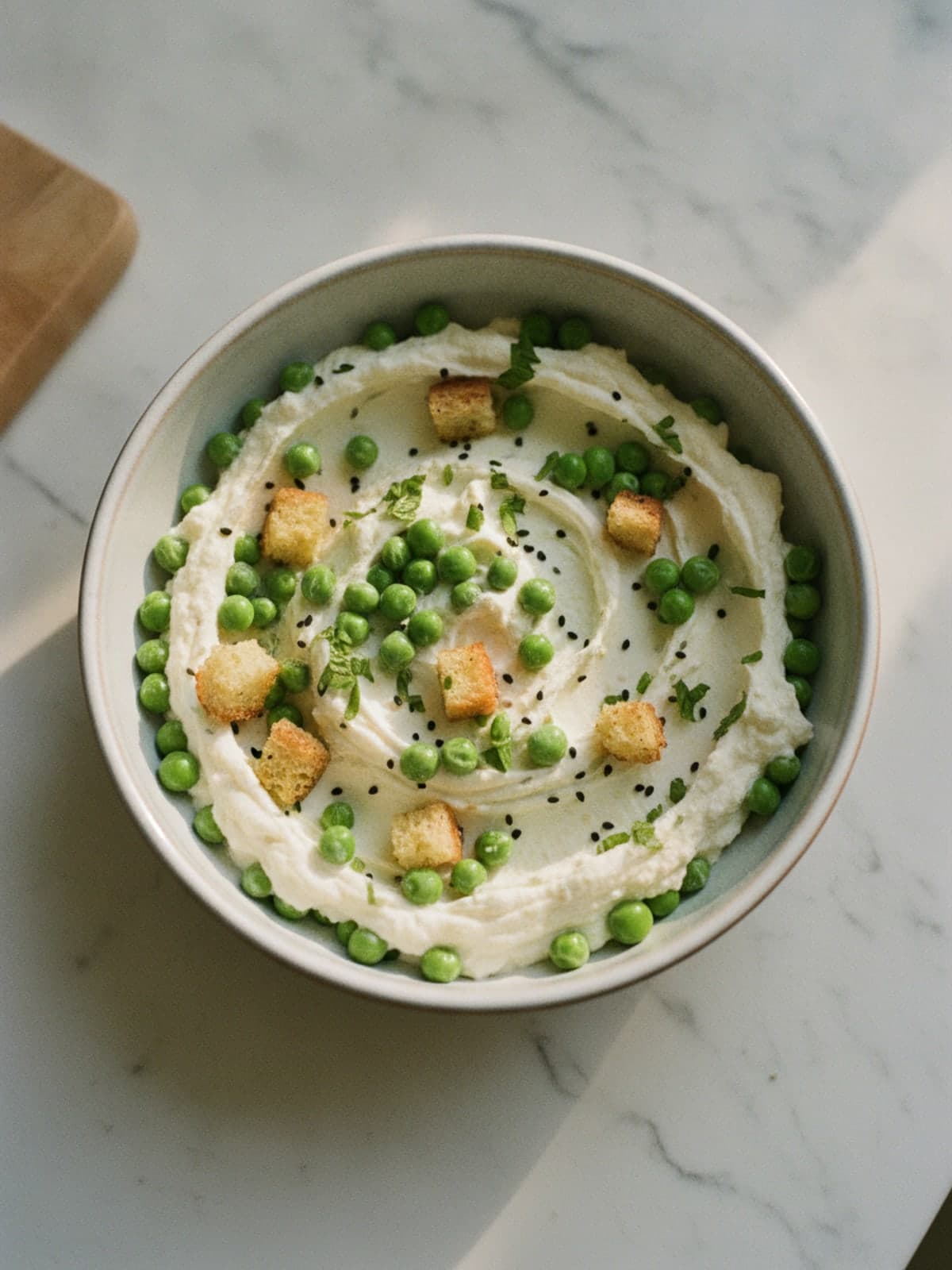 Whipped Feta and Spring Pea Crostini: Blend feta into soft swoops